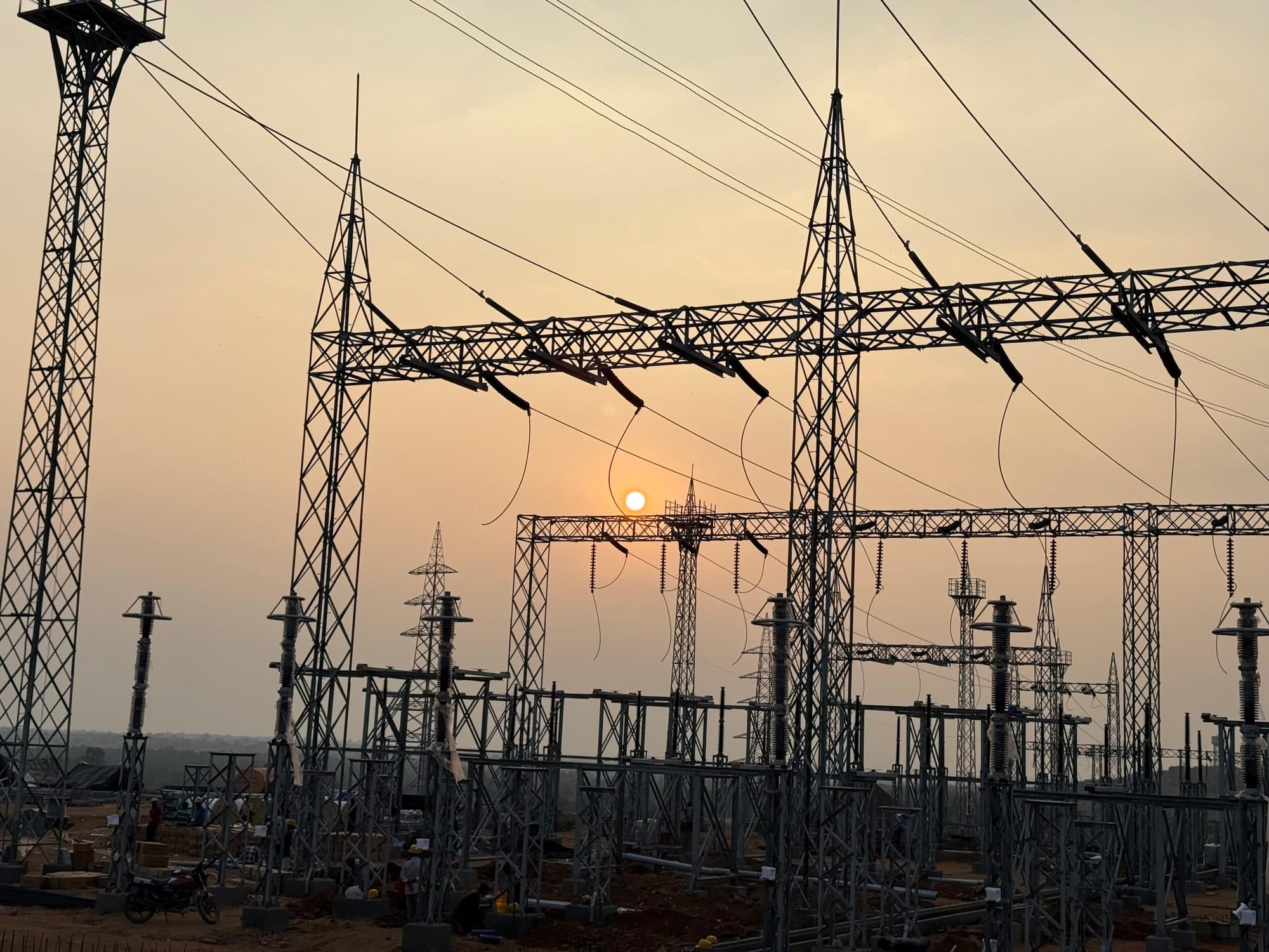 Switchyard gantries against the setting sun