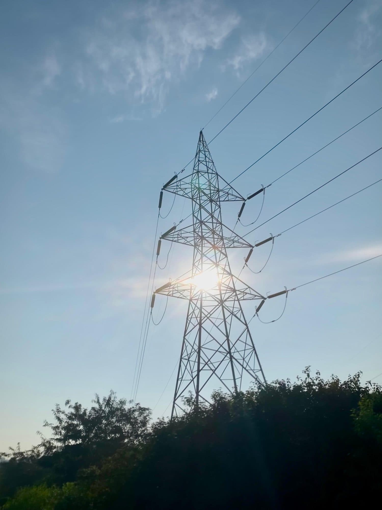 The sun bursting through a lattice tower