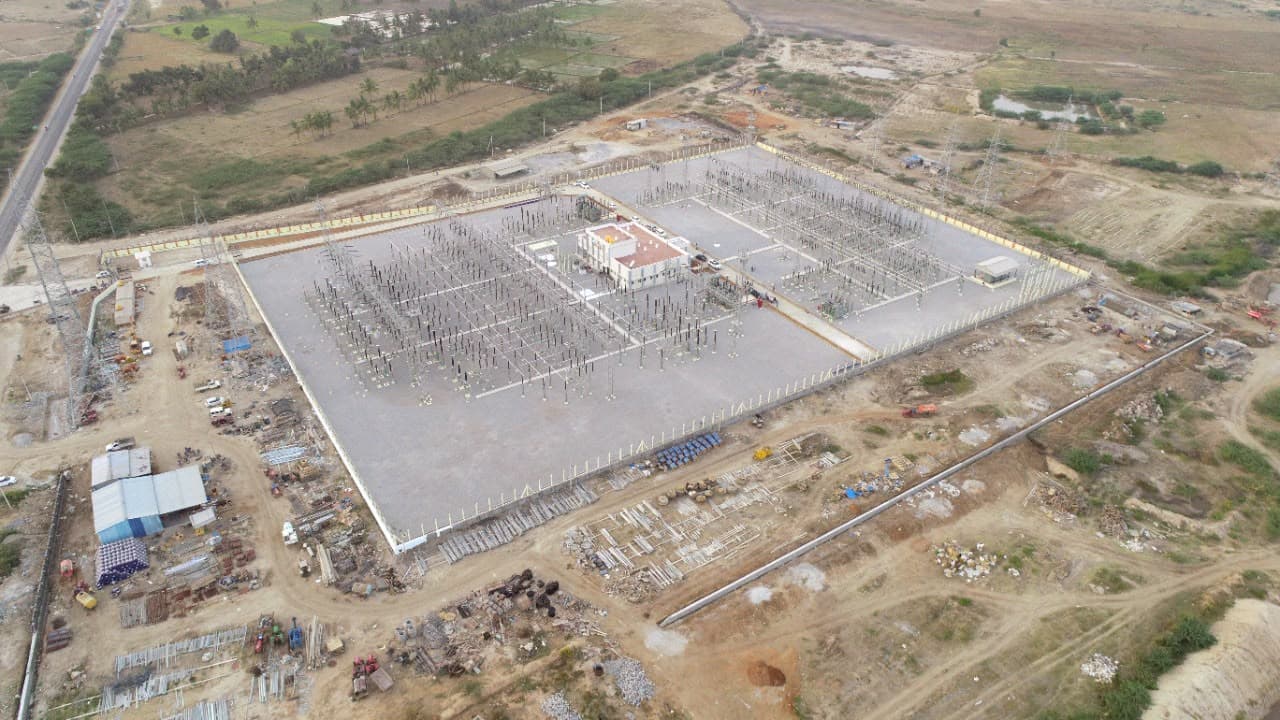 Aerial view of a sub-station yard nearing completion, the stores and material yard beside it
