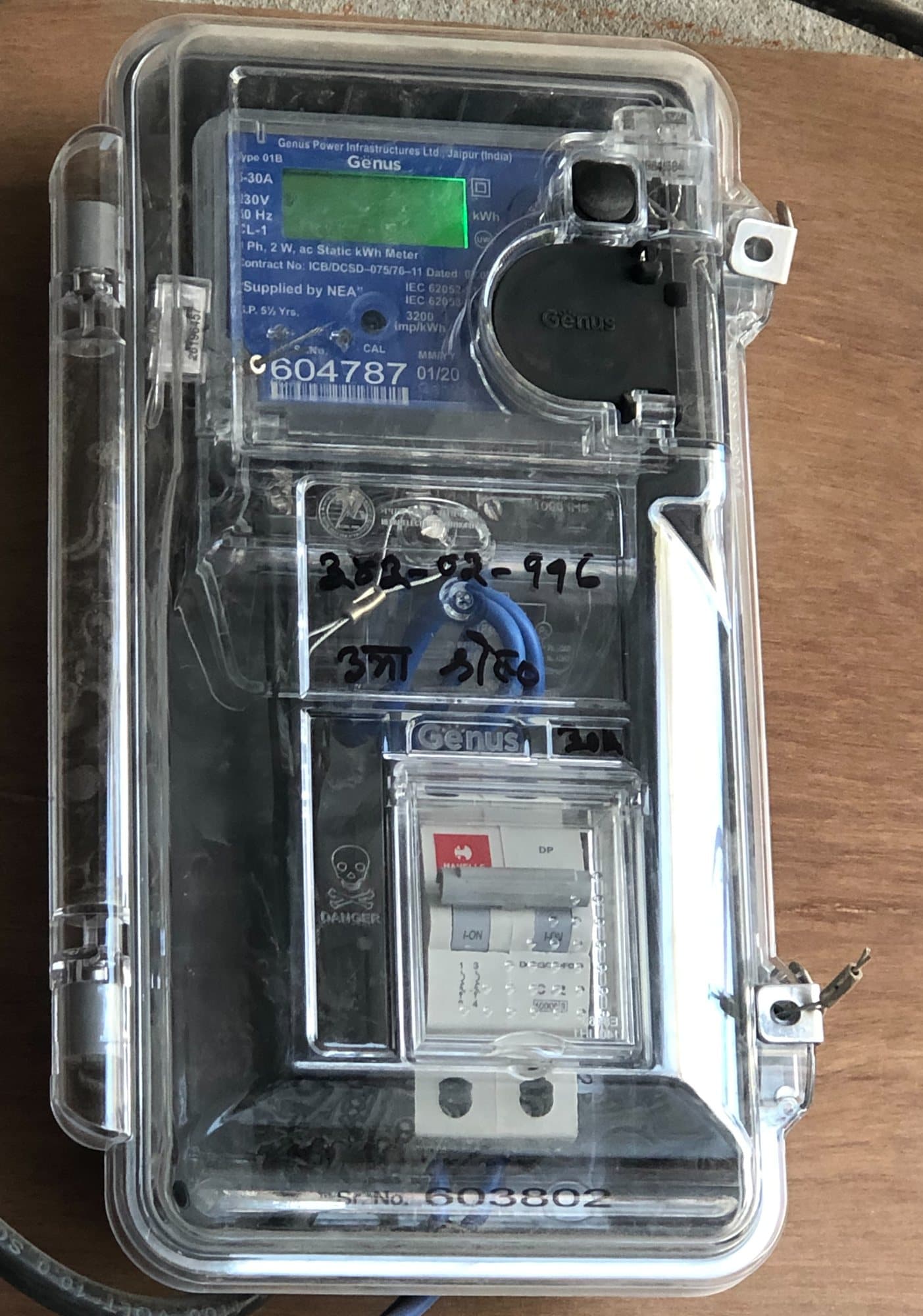 A static energy meter and its circuit breaker in a sealed transparent box