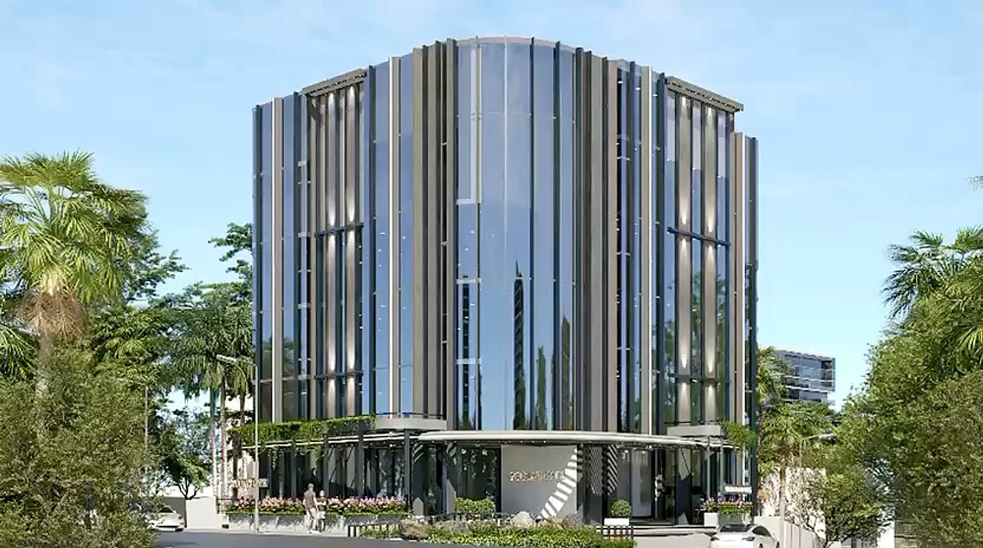 The company's Bengaluru office: a glass tower with vertical fins over a planted podium and entrance canopy