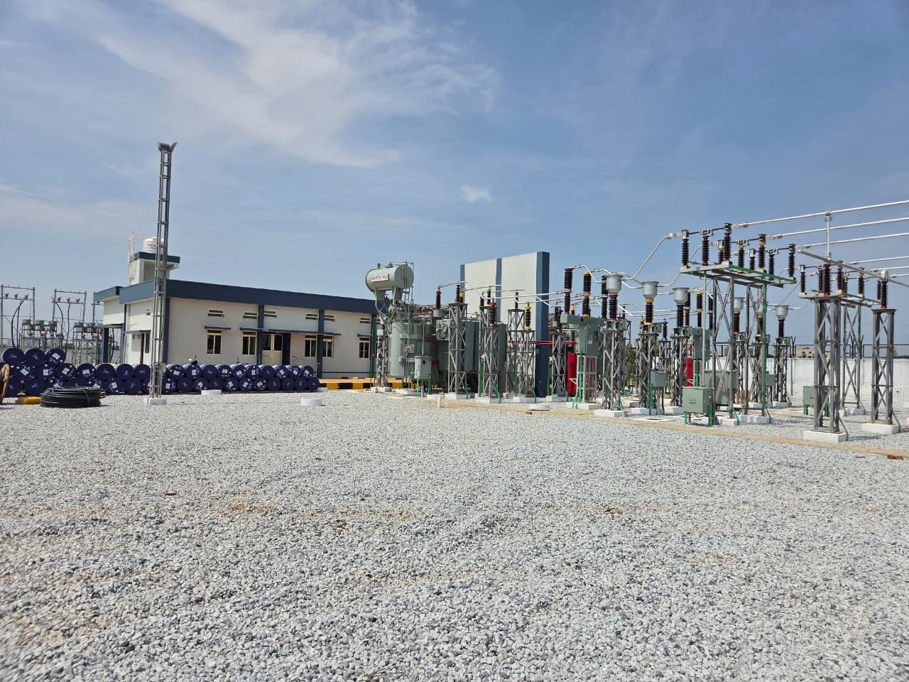 The control building, transformers and bays across the gravelled yard