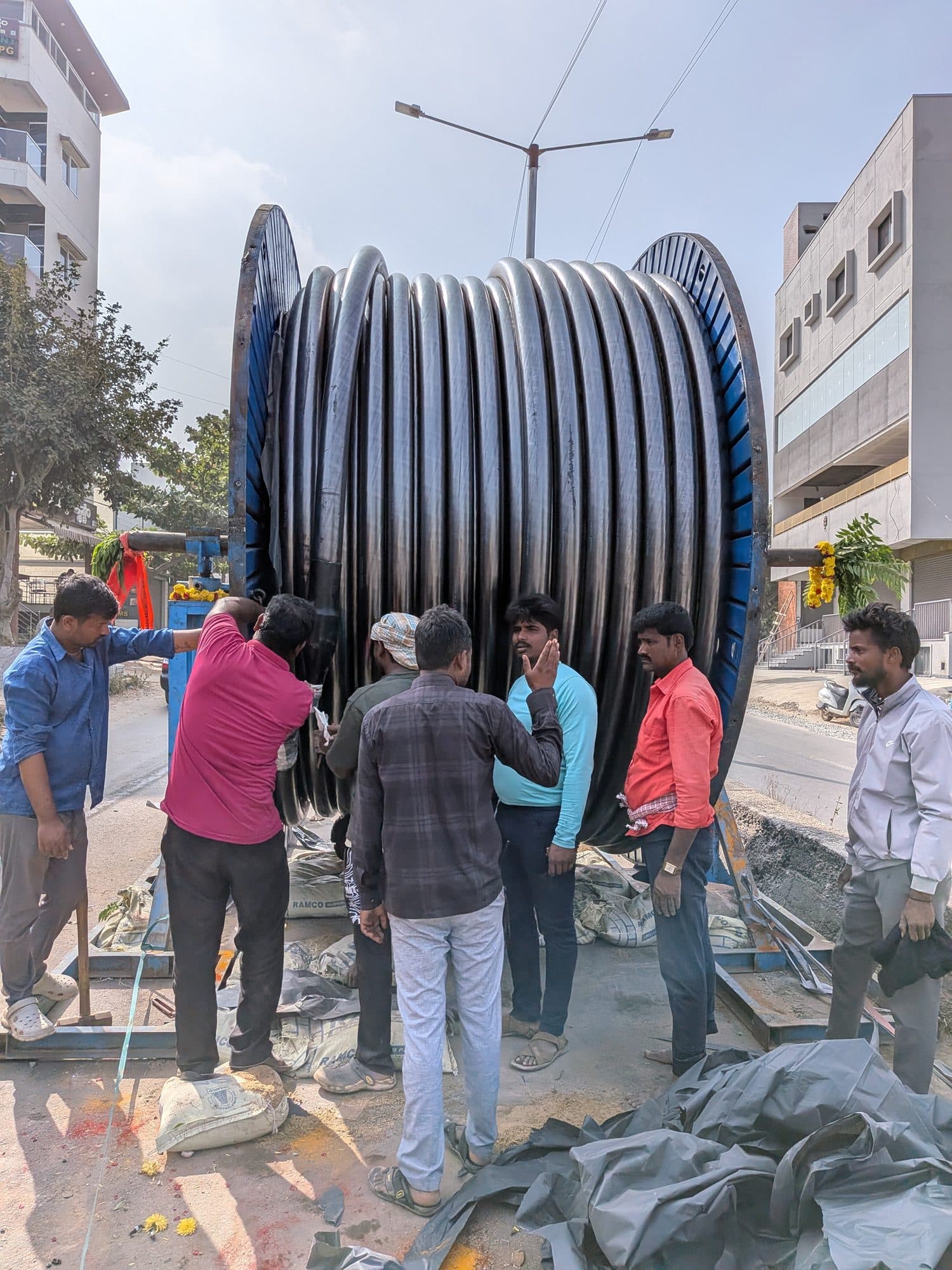 The crew at a cable drum on its stand