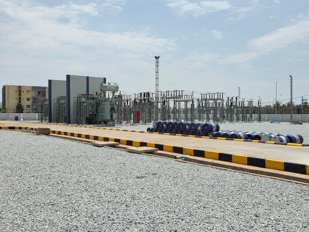 Transformer plinths, the kerbed road and oil drums