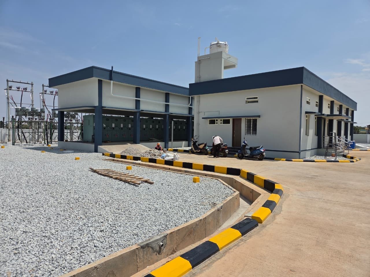 The control building, the kerbed road and its drain