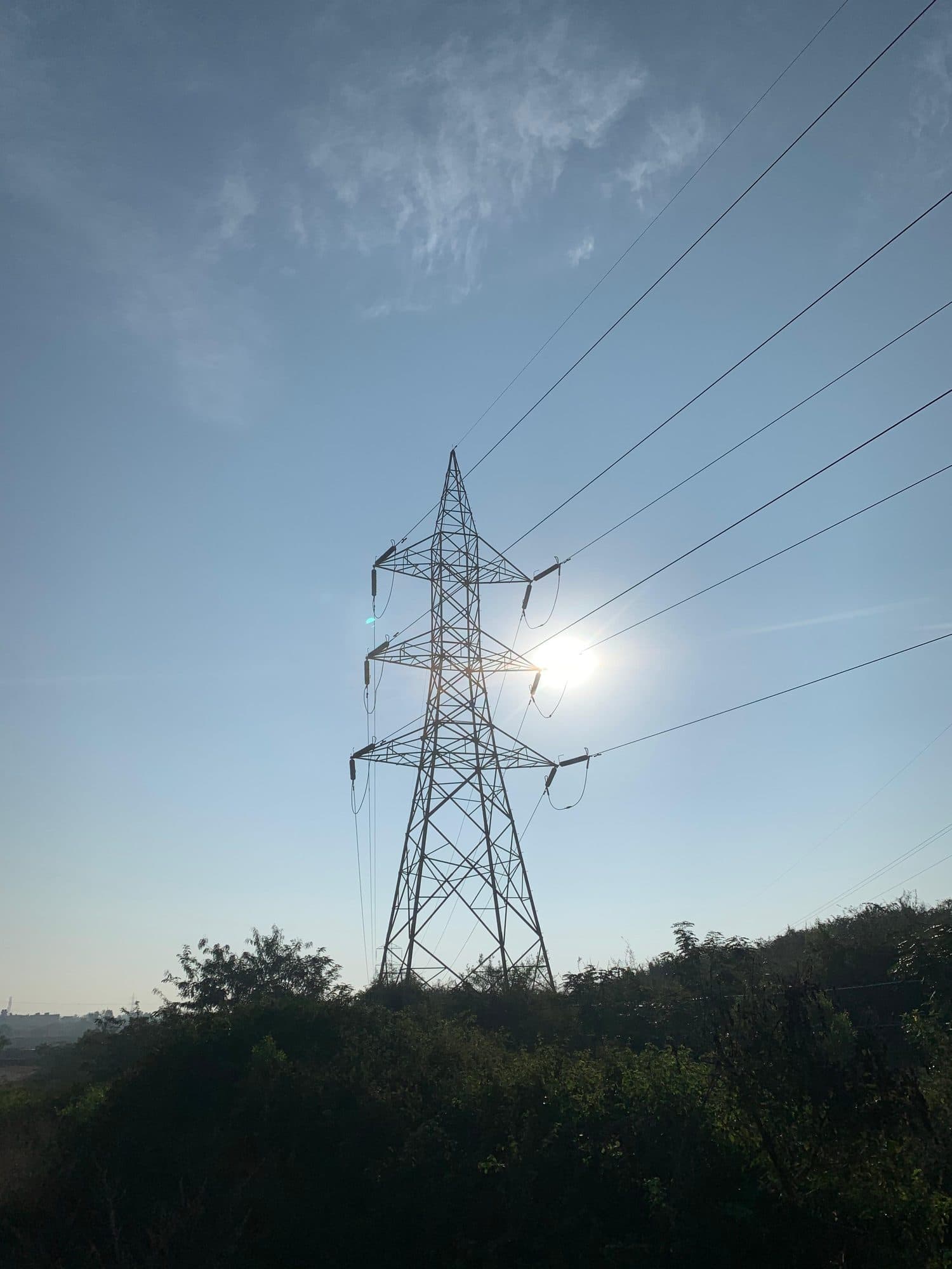A tower against the sun above the scrub