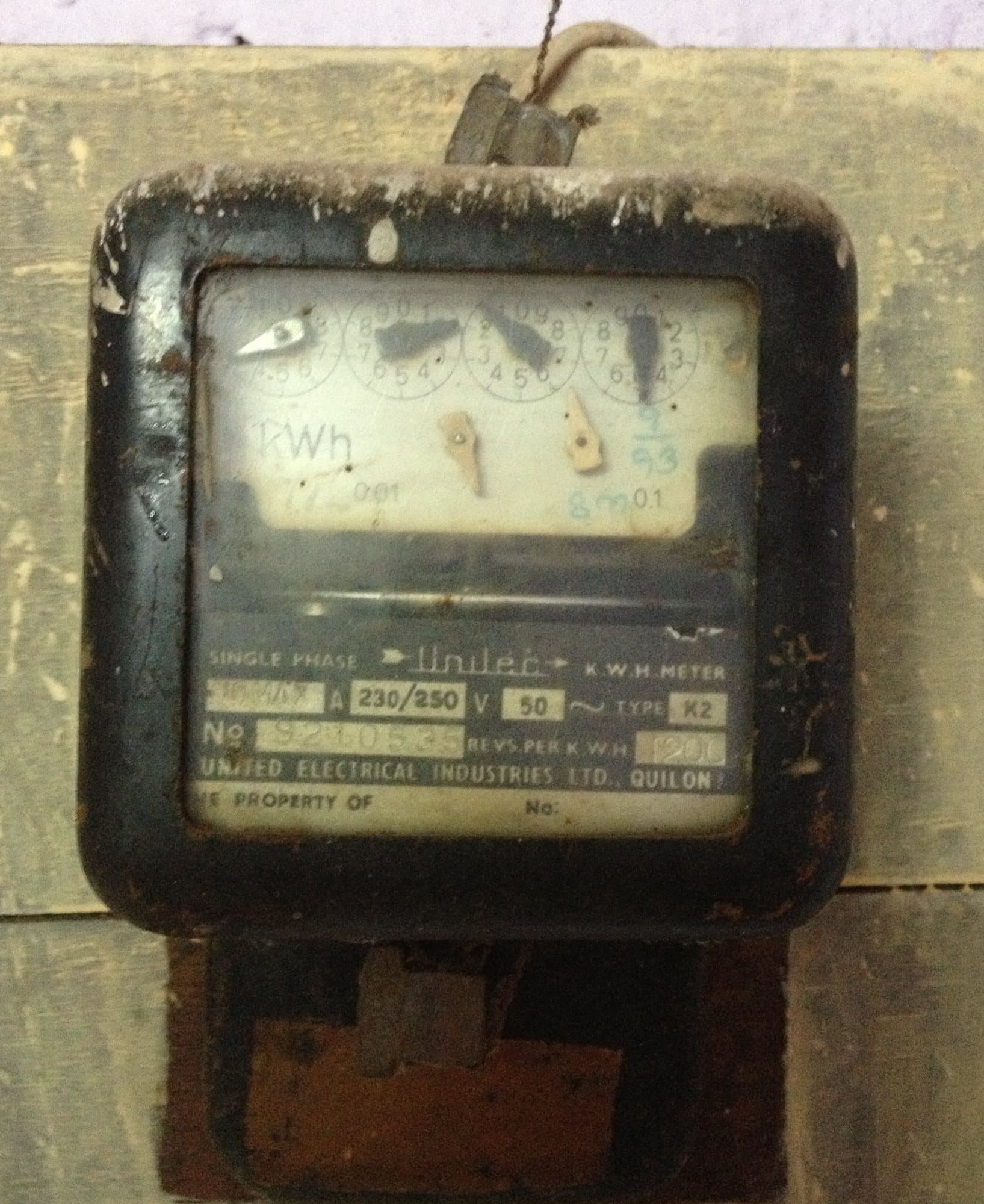 An old single-phase electromechanical energy meter with its rotating disc