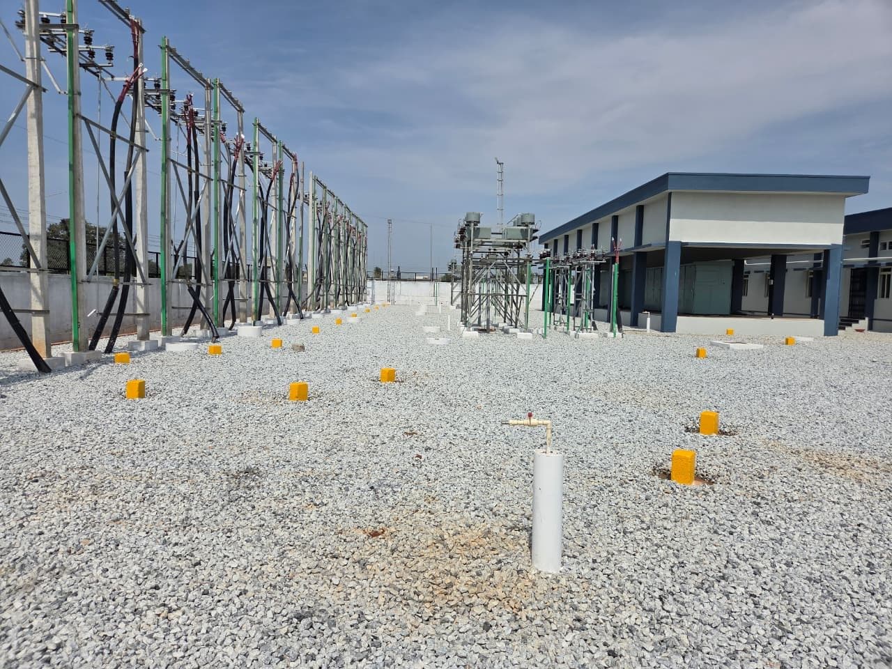 Earth pits across the yard, the control building beyond