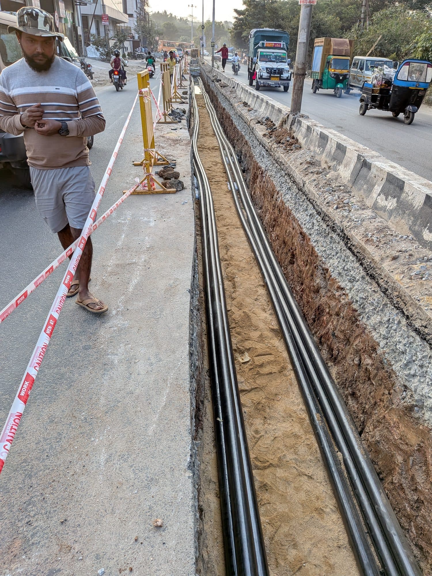 A cable trench along a city road, the cables laid in it