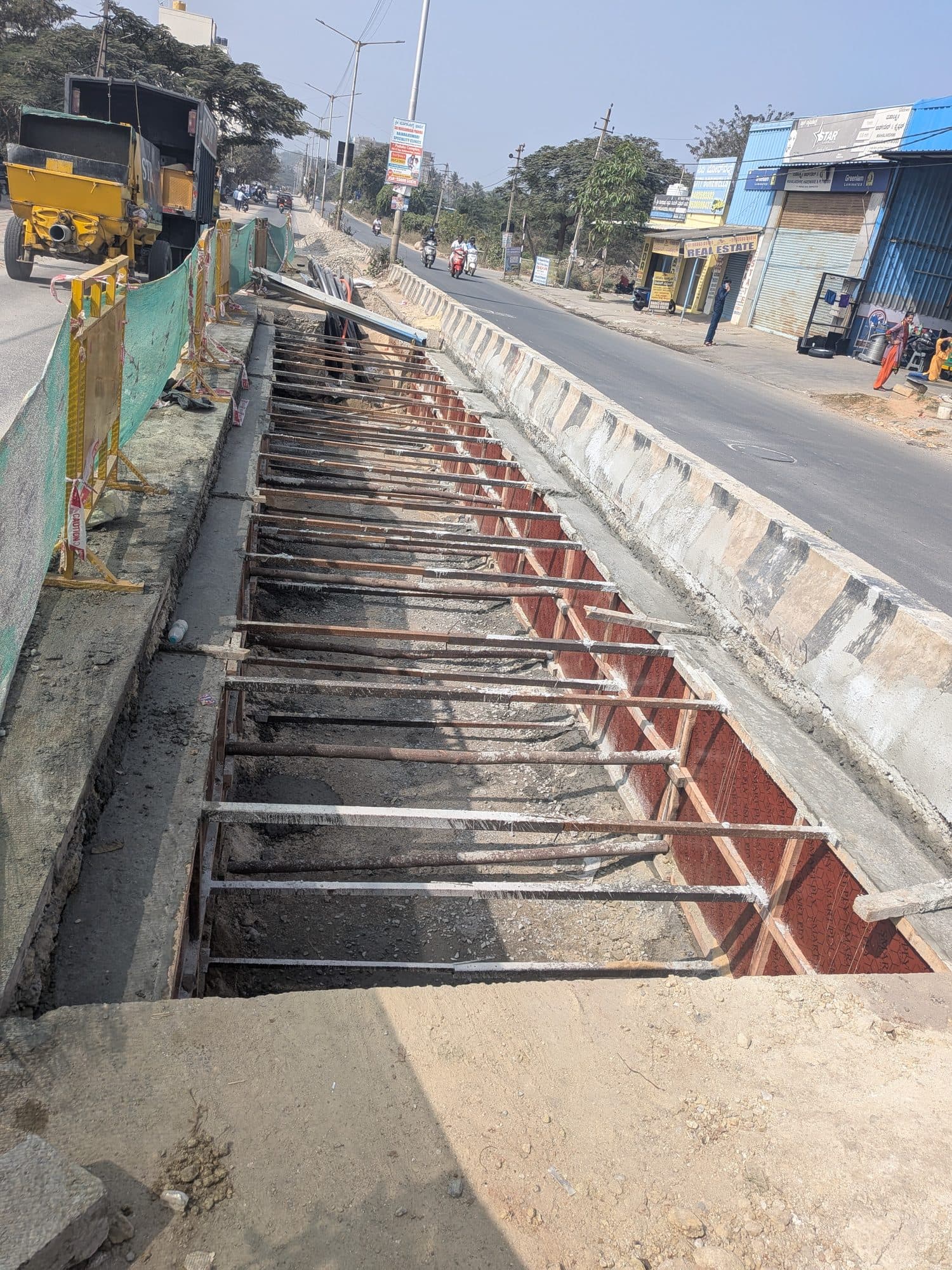 Cable rollers set along the trench beside the road