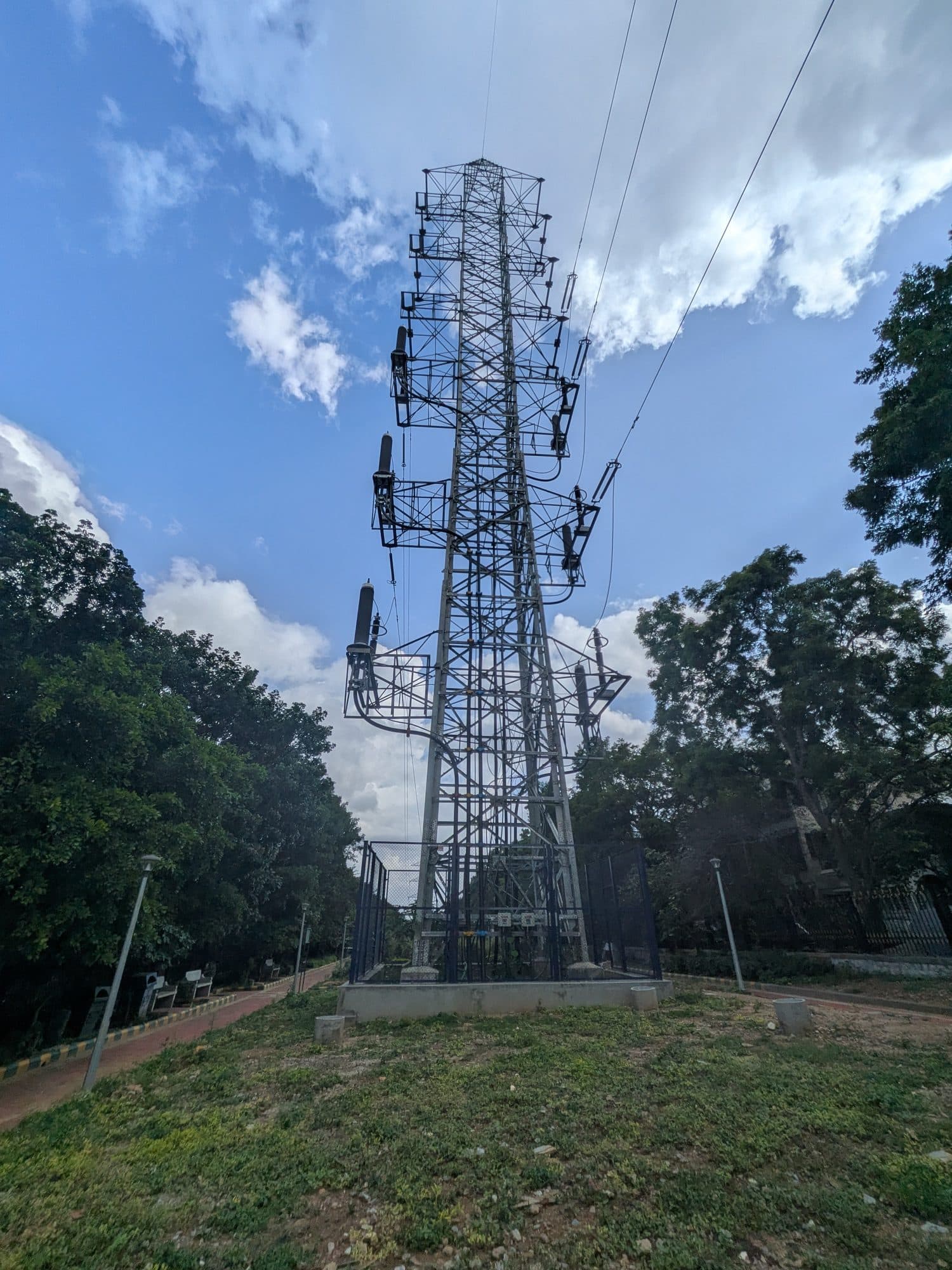 A lattice transmission tower among trees